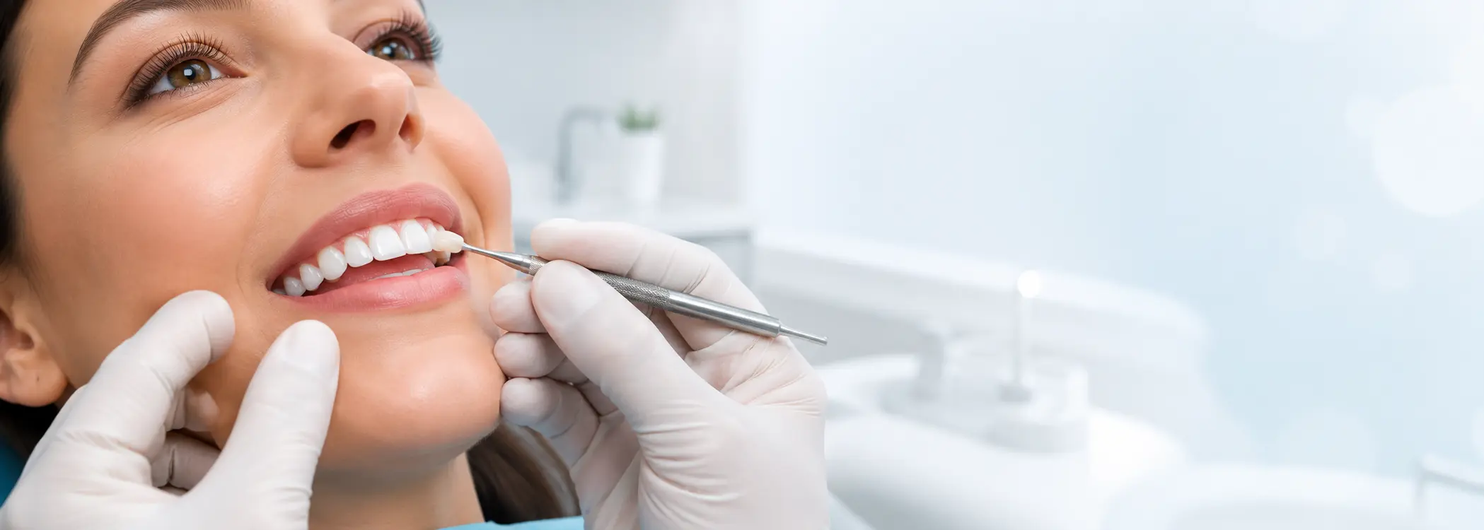 Dentist applying tooth-colored composite bonding at Toothology Williamsburg
