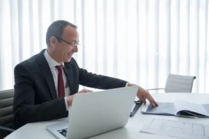 Adult Reviewing Insurance , Laptop
